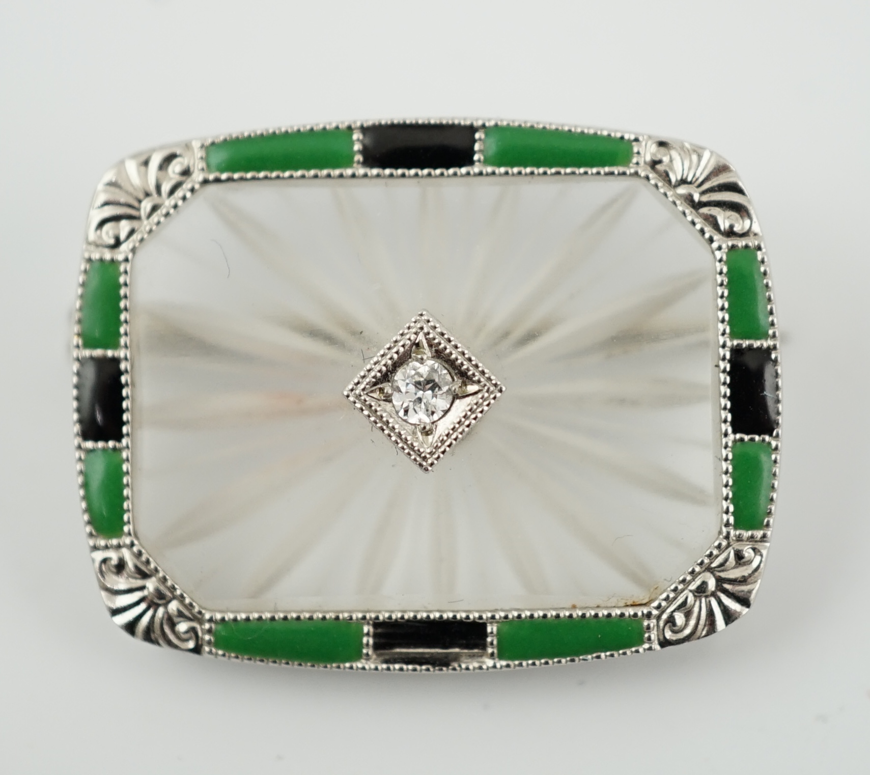 An Art Deco white gold, rock crystal, black onyx, chrysoprase and diamond set brooch